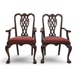 Chippendale design set of ten (8+2) mahogany dining chairs, serpentine cresting rails with carved detail over pierced ribbon-tied splats, red damask upholstered drop-in seats, on cabriole supports with acanthus carved knees and claw and ball feet
