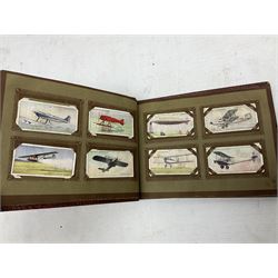 Three albums of cigarette cards including Wills Recruiting Posters, Military Motors and Allied Army Leaders, cricketers etc; another album containing a large quantity of laid-in cigarette cards; and an album of thirty-seven postcards of dogs by Mac (5)