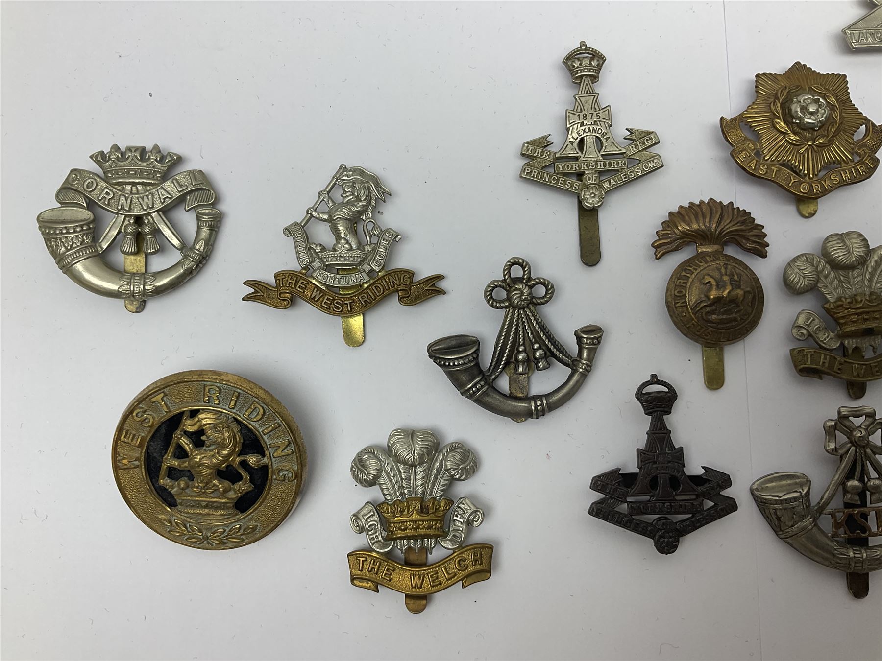Over thirty regimental cap badges for fusiliers, Yorkshire interest, Light Infantry etc including Royal Scots and Welsh fusiliers, Durham L.I., KO Yorkshire L.I., Oxford & Bucks L.I., Green Howards, East Yorkshire, West Riding, York North Riding etc 