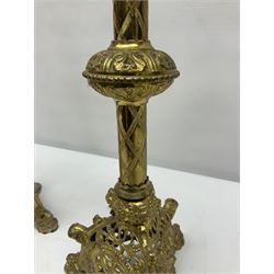 Pair of gilt metal pricket candlesticks, with applied decoration on knopt stems and triform bases, H47cm