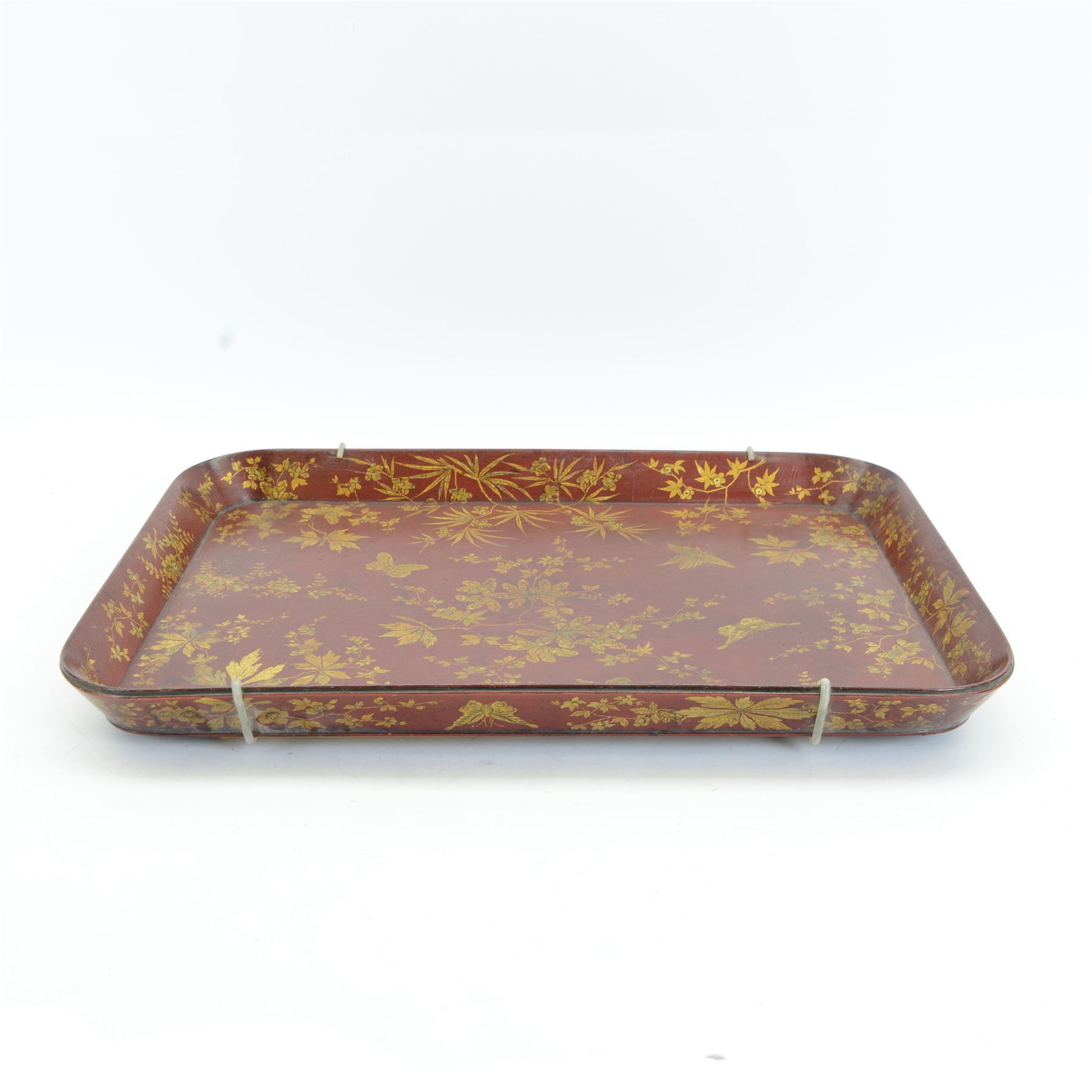 Early 19th century red lacquered papier-mâché tray by Clay of King Street Covent Garden, of rounded rectangular form, painted in gilt with large foliate sprays and butterflies, impressed verso CLAY KING ST COVENT GARDEN, W66.5cm D48.5cm