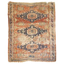 Antique Caucasian crimson ground carpet. the field decorated with three geometric indigo m...