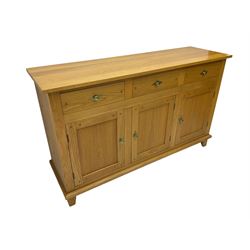 Light oak sideboard, rectangular top, fitted with three drawers and three panelled cupboards, on square feet