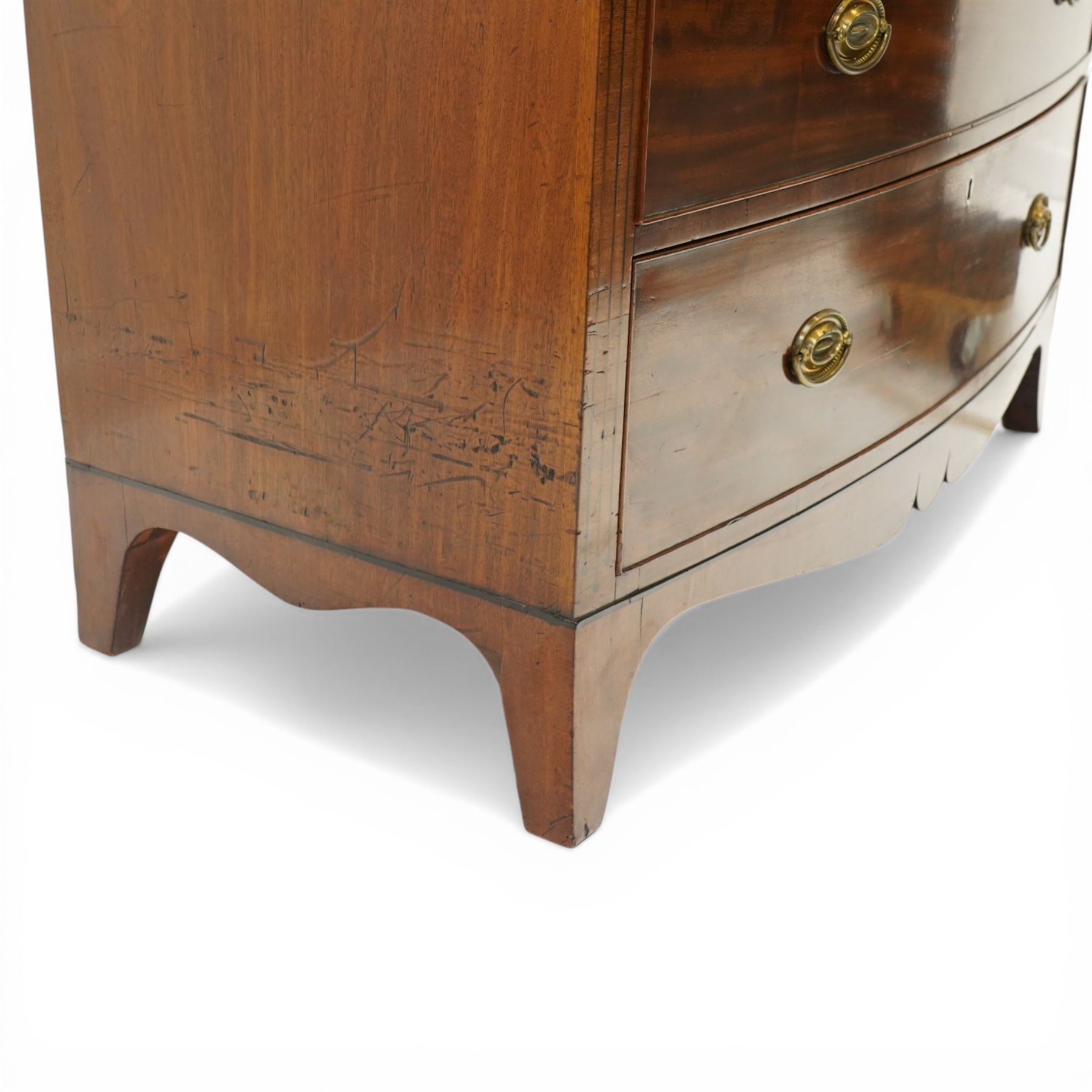 Early 19th century Regency mahogany bow-front chest, with banded caddy top and ebony stringing, fitted with two short over three long cockbeaded drawers, with oval brass handles, shaped apron and splayed bracket feet