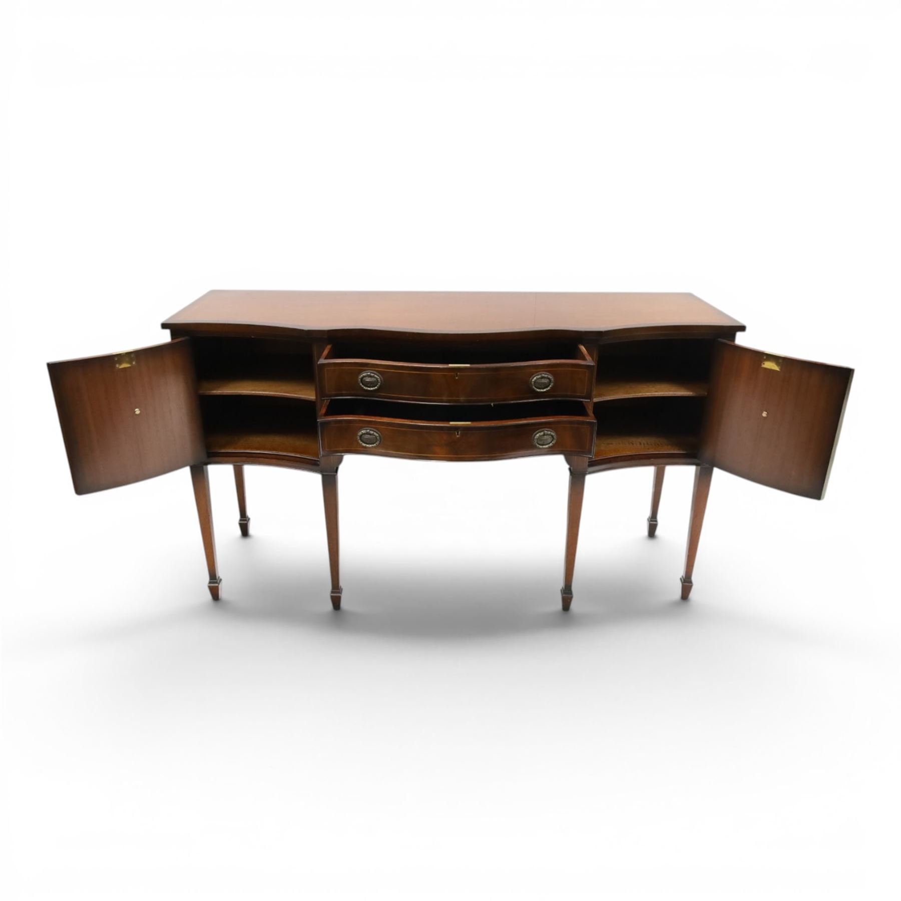 Georgian design mahogany serpentine sideboard, shaped top over two central drawers flanked by cupboard doors, flame mahogany veneered fronts with satinwood stringing, oval brass handles, shaped apron, on square tapering supports with spade feet