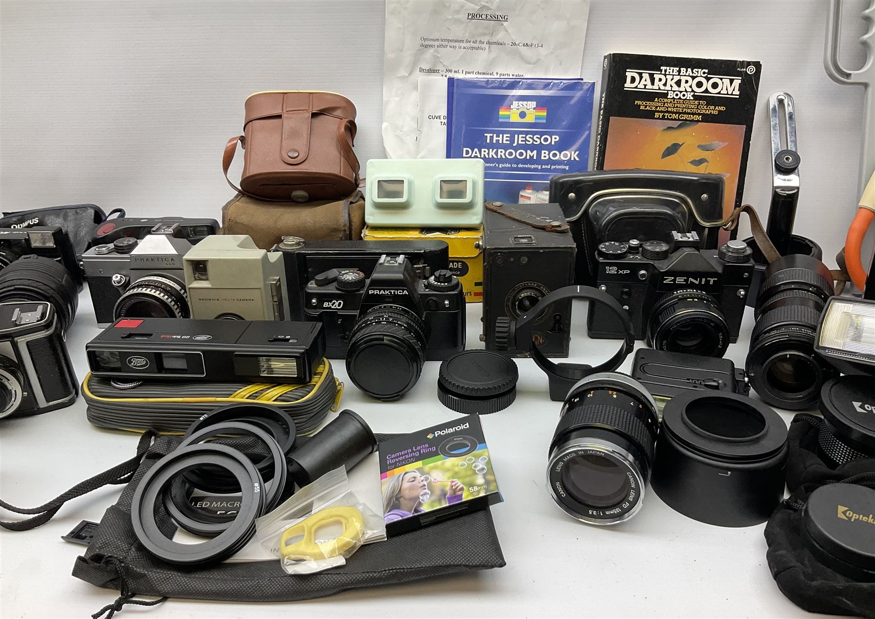 Vintage and later cameras, lenses, accessories and darkroom equipment including Zenit 12XP camera, Praktica BX20 camera fitted with 'Sigma Zoom Master 1:3.5-4.5 f=35-70mm' lens, Praktica LLC camera fitted with 'Carl Zeiss Jena Pancolar 1.8/50' lens, Canon Zoom Lens 'EF 100-300mm 1:5.6', various Jessop and other makers darkroom items including safelight (Red), universal duo tank, multi-mask enlarging easel etc, in three boxes