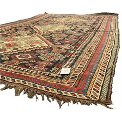 Old Persian Hamadan rug, the indigo ground field with three interlinked lozenge medallions, decorated all over with geometric and stylised motifs, eight band border with repeating geometric patterns 