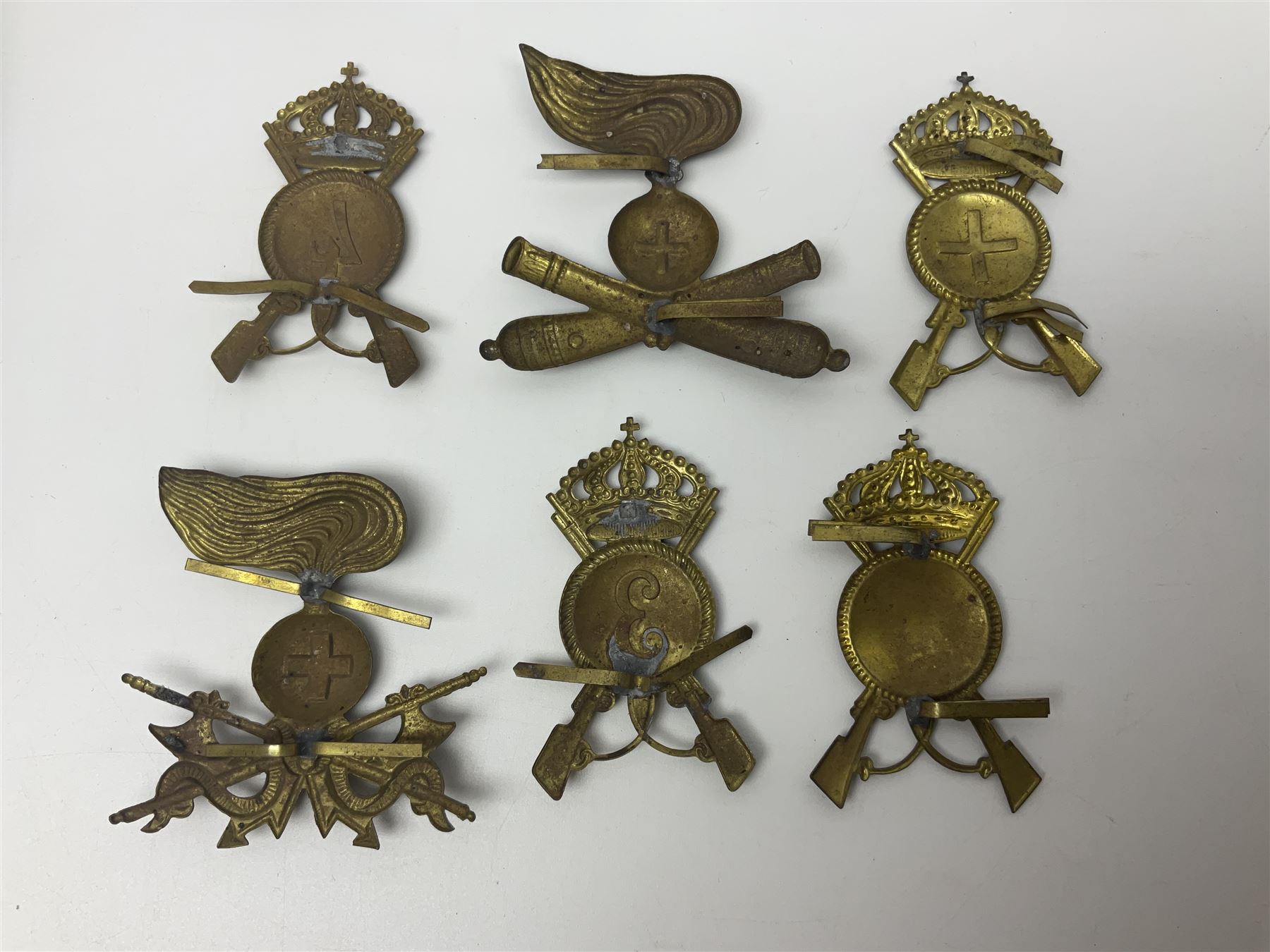 Over thirty British and Continental military metal badges; together with quantity of shoulder titles, collar dogs, rank pips, uniform buttons etc