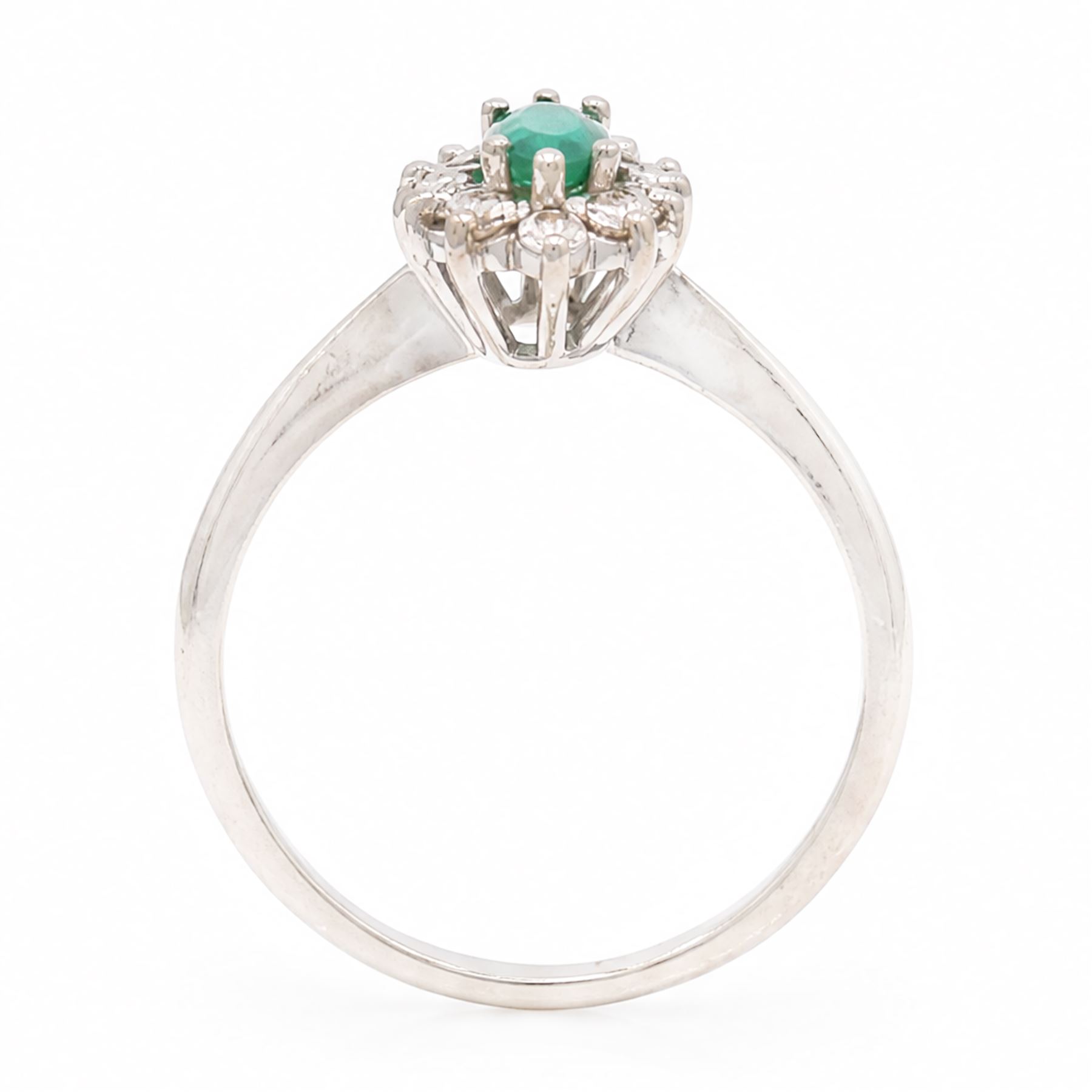 18ct white gold emerald and diamond cluster ring, single marquise cut emerald 0.25 carat, surrounded by twelve round brilliant cut diamonds, London 1979, total diamond weight approx 0.25 carat