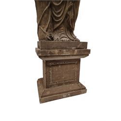 Hand carved stone Neoclassical figure of the Roman goddess Flora, her hair pinned with roses, draped in a toga, holding a basket of flowers in her right hand, raised on a stepped square plinth base 