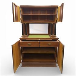 Continental Art Nouveau cocktail cabinet, the stepped cornice over a glazed upper section with panelled doors, enclosing fitted shelf, the central section with mirrored back and green baize serving surface flanked by ebonised and gilt detailed pilasters, the base fitted with cupboard doors inlaid with stylised foliate and geometric motifs, on a plinth base