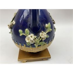 Minton majolica vase, the squat body with twin handles, with part osier moulding and applied Spring flowers against a cobalt blue ground, upon integral square base, impressed beneath Minton 1316, H16.5cm