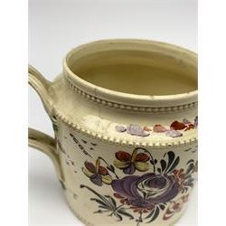18th century creamware teapot, probably Leeds, with reeded entwined handle and floral finial to the cover, the body with hand painted polychrome decoration of figure to one side, and floral spray to the other, collectors paper label beneath inscribed Leeds Pottery, H11.5cm