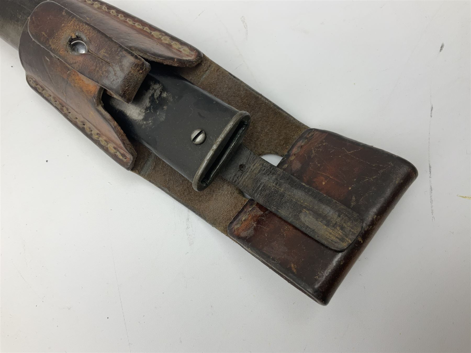 British Enfield 1907 model SMLE bayonet, with 43cm fullered steel blade and metal mounted leather scabbard L58cm overall; and Schmidt-Rubin Model 1918 bayonet the 30cm steel blade marked Elsener Schwyz No.579722; in steel scabbard with leather frog marked G. Bertolini Sellaio Vira/G.Tic 79 L45cm overall (2)