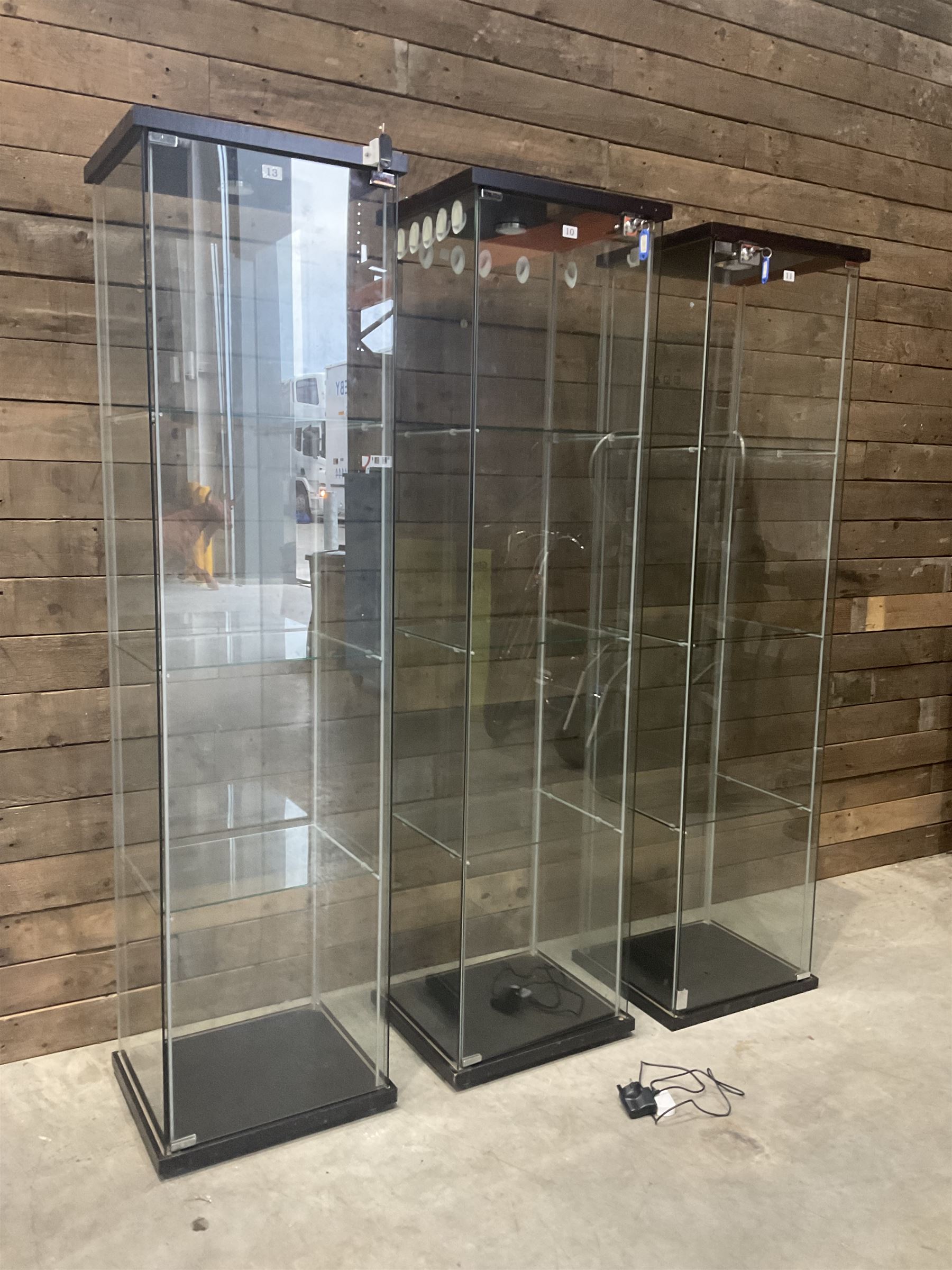 Three Ikea rosewood finish illuminated four glass shop display cabinets, with shelves and keys
