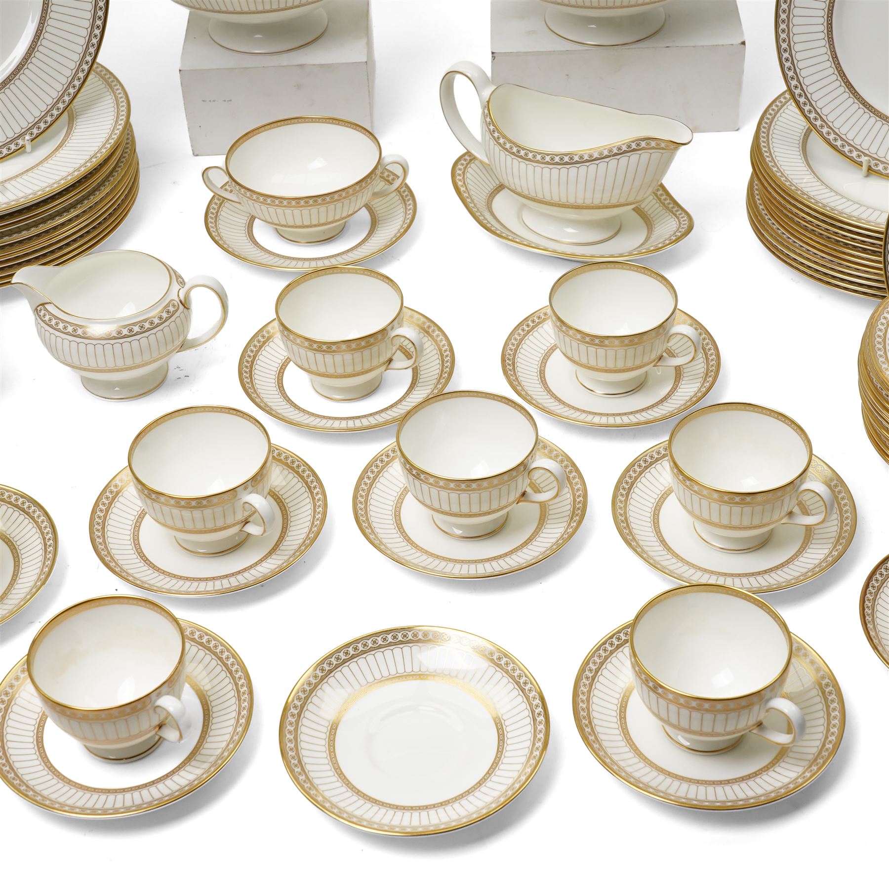 Wedgwood 'Colonnade' pattern dinner and tea service comprising twelve dinner plates, twelve dessert plates, nine soup bowls and stands, pair of covered vegetable dishes, sauce boat and stand, eight tea cups and saucers, thirteen tea plates, milk jug and sugar bowl