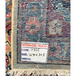 Northwestern Persian Meshkin hand-knotted carpet, the ivory field with an all-over design of scrolling vines and stylised floral sprays in burgundy, pink, and blue tones, enclosed by a raspberry red border of rosettes and palmettes linked by fine arabesques, from the region of Meshkin near Ardabil