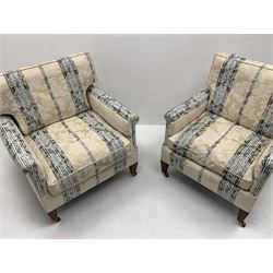 20th century hardwood framed three piece lounge suite consisting of two seat settee (W156cm, D82cm) and pair matching armchairs (W72cm), exposed mahogany feet with brass castors, upholstered in cream ground and blue Regency stripe floral patterned fabric
