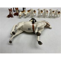 Beswick hunting group, comprising huntswoman on grey horse no 1730, huntsman on brown horse no 1501, two seated fox figures no 1748 and seven fox hounds, all with printed marks beneath (11)