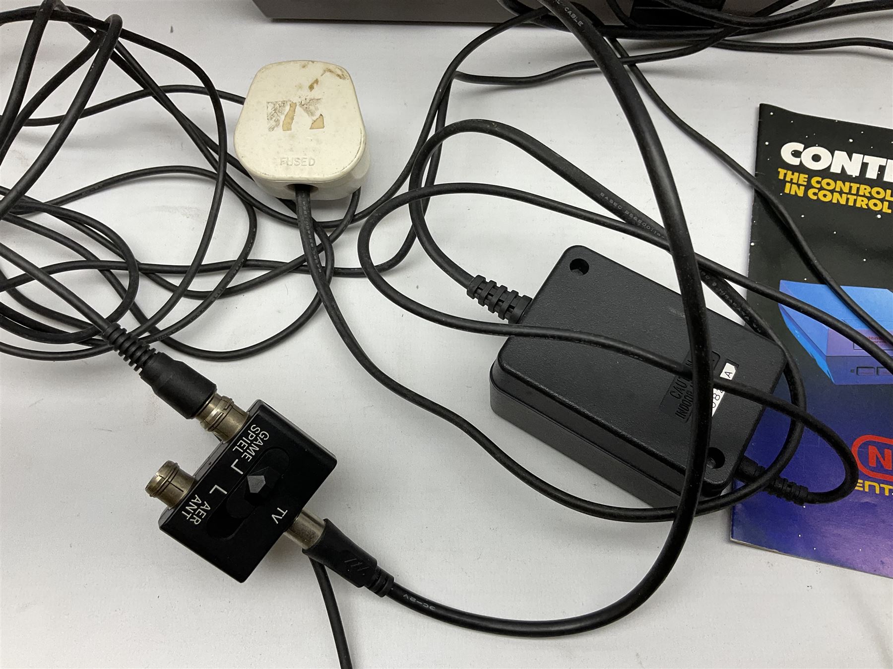 Nintendo Entertainment System (1985) console with two controllers, accessories and instruction booklet. NES Games ‘Duck Hunt’ with Nintendo Zapper gun, ‘Pinball’ and ‘Super Mario Bros.’, all with original sleeves and instruction booklets. NES game ‘Super Mario Bros. 2’ cartridge only