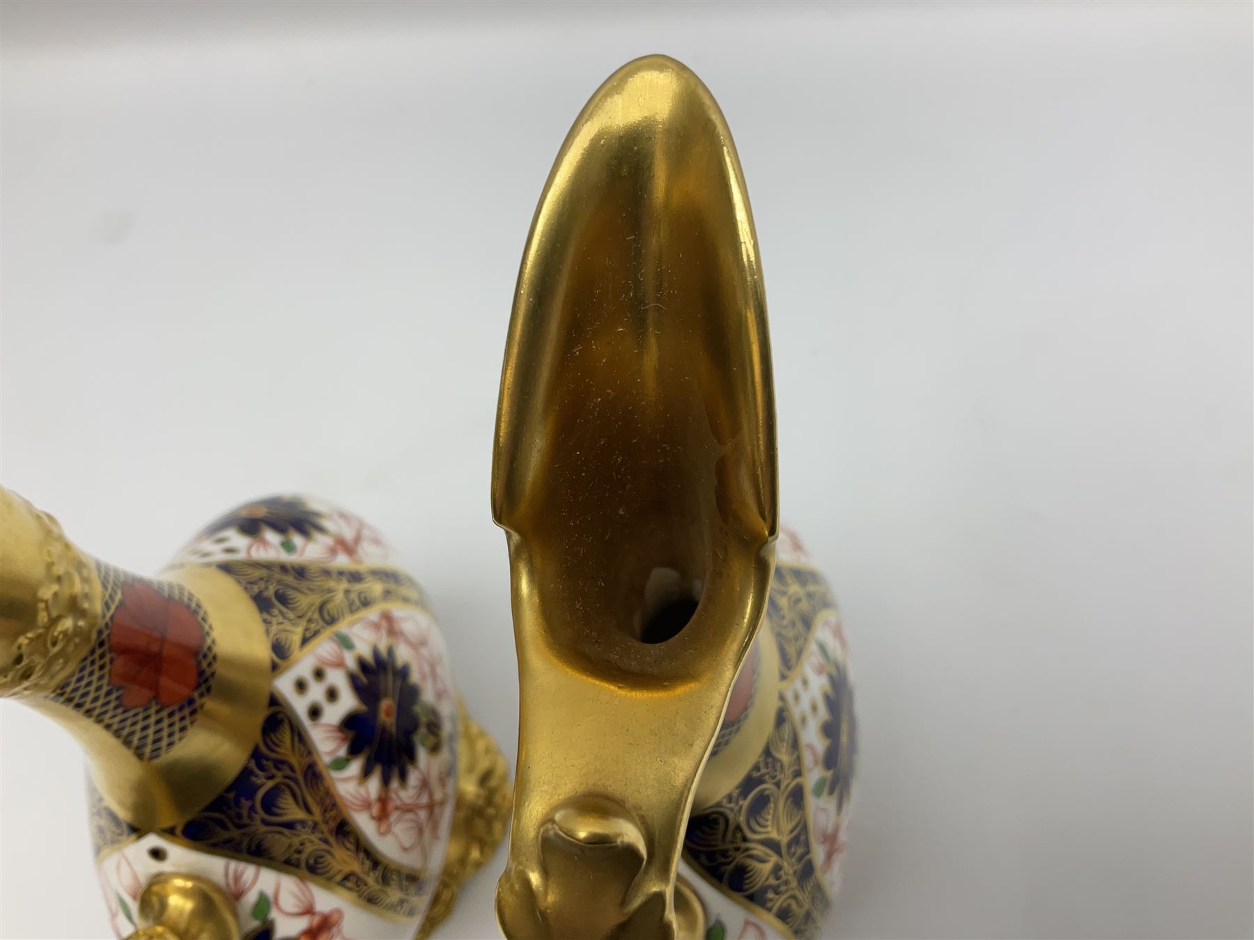 Pair of mid 20th century Royal Crown Derby Imari 1128 pattern Kedleston ewers, each with gilt scroll handle and neck, upon a gilt quatrefoil foot, each with printed marks beneath, H25.5cm