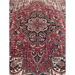Persian Heriz red ground rug, large medallion decorated with palmettes and Ejder motifs, the border decorated with stylised plant motifs, within floral design guard stripes 