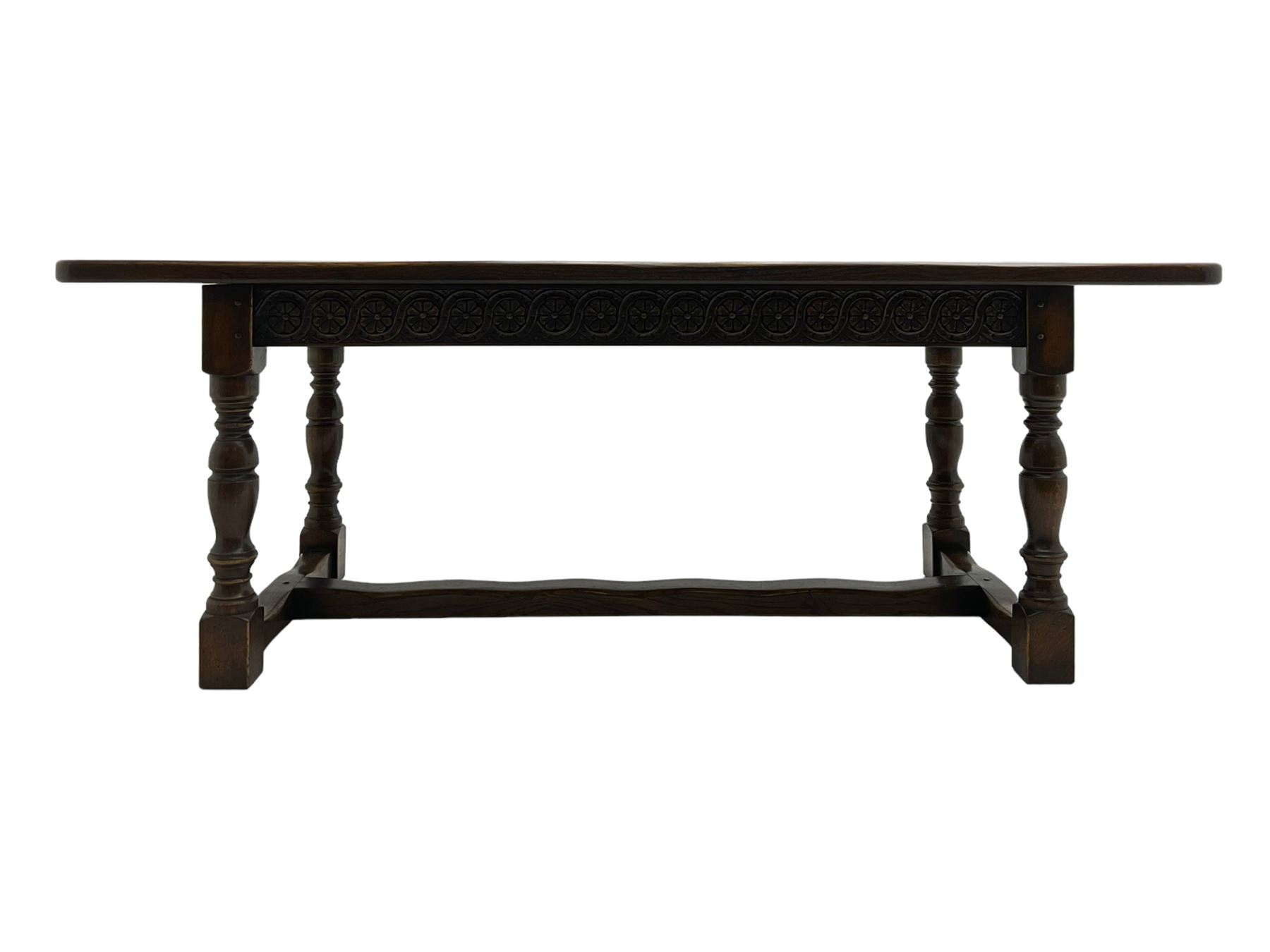 Large oak refectory dining table, rectangular top over guilloche carved frieze rails, turned supports joined stretchers