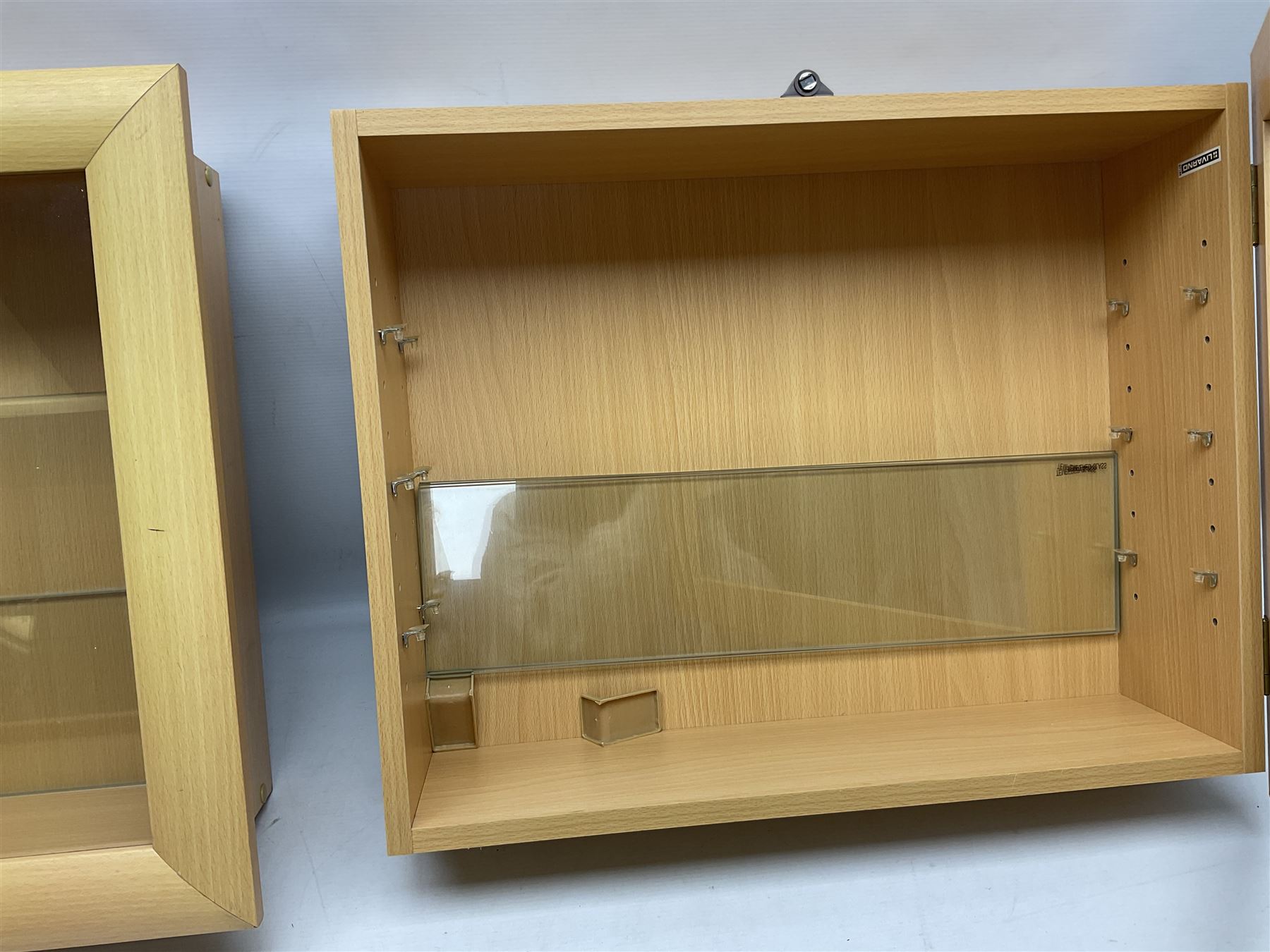 Set of four Livarno wall mounting model display cabinets, each with simulated beech finish and side hinged glazed door enclosing adjustable plate glass shelves W62.5cm H50cm D17cm (4)