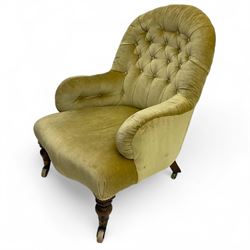 Late 19th century button-back nursing chair, upholstered in olive-green velvet, shaped back with padded arms, raised on turned front supports terminating in castors