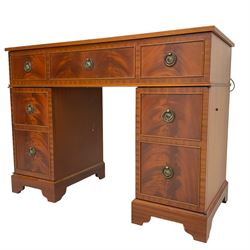 Music system in the form of a Georgian design twin pedestal desk, the reed moulded rectangular top hinges to reveal Garrard turntable with Dynatron Amplifier, fitted with speakers enclosed by two doors disguised as drawers, on bracket feet