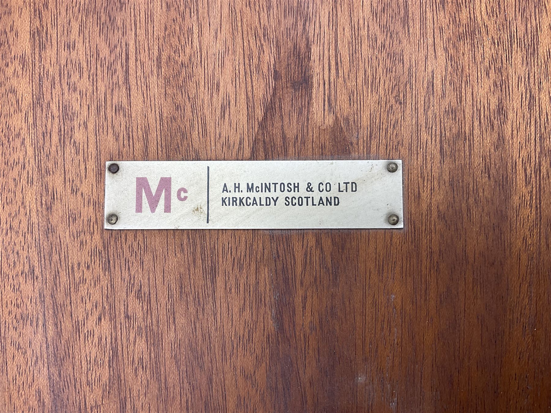 Tom Robertson for AH McIntosh & Co of Kirkaldy - mid-20th century teak extending dining table, rectangular top with rounded corners, concealed integrated double leaf, raised on tapered supports, metal label to underside of leaf