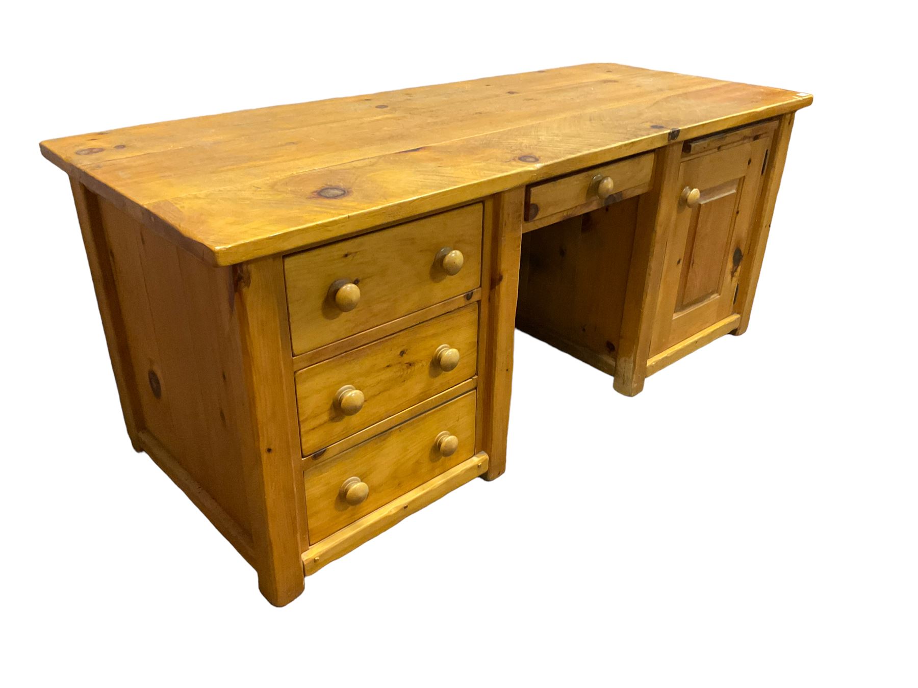 Large pine desk, rectangular top over four drawers, slide and panelled cupboard