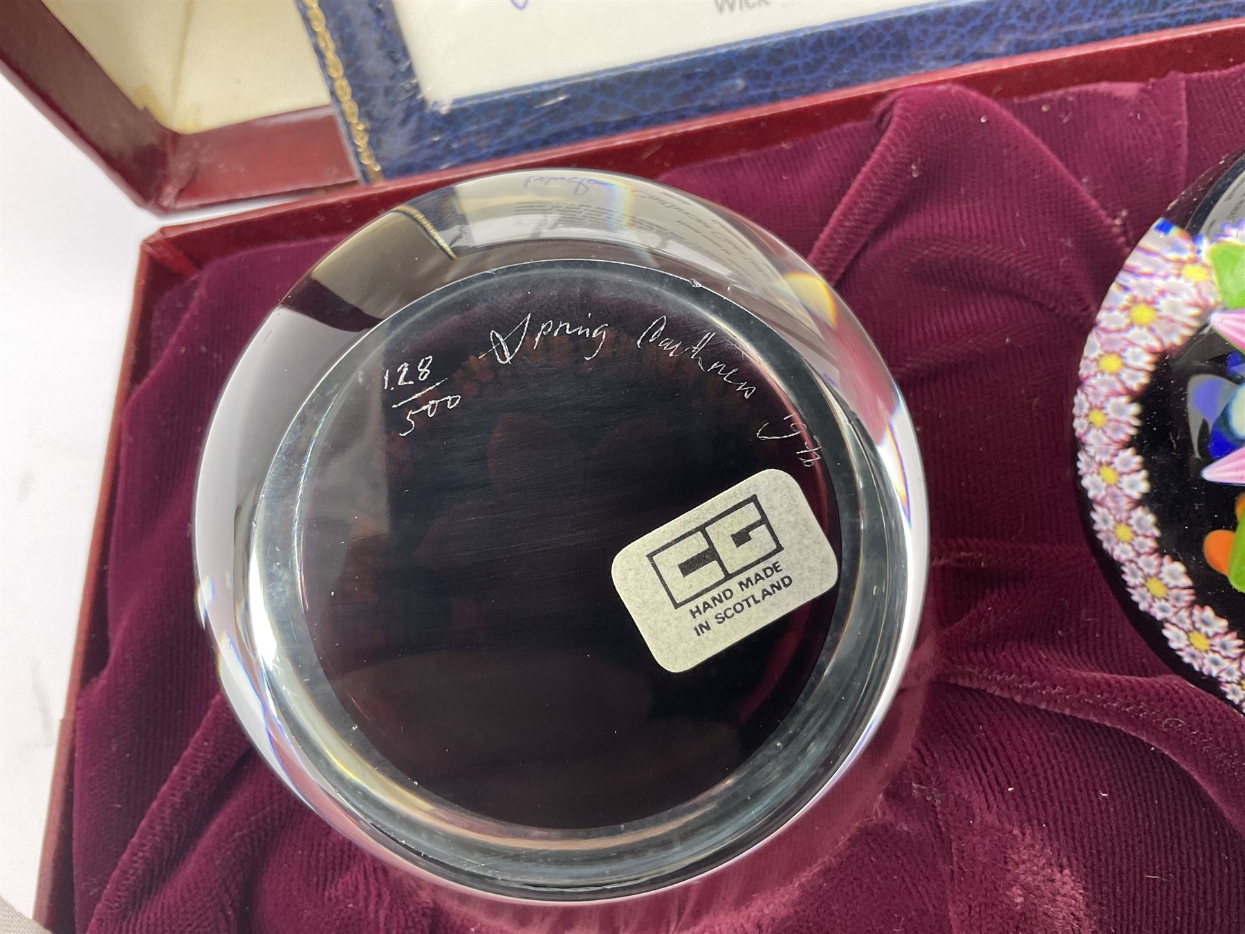 Set of four Caithness paperweights titled Four Seasons, in presentation box with certificate, designed by Colin Terris and made by William Mason, each internally decorated with a seasonal flower within a millefiori cane work garland, numbered 128 of 500