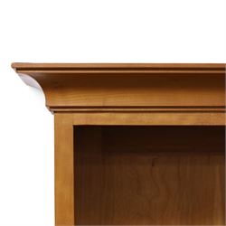 Philip Koomen (1953-) - Craftsman-made modern cherrywood large open
bookcase with a cupboard base, upper section with a
shaped cornice above three sections with two open
shelves, the lower section has three cupboards,
each with two panelled doors enclosing a single
shelf, raised on a plinth base