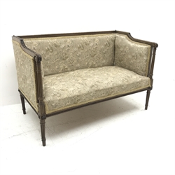 Edwardian mahogany framed two seat sofa, acanthus carved scrolling arms, turned tapering reeded supports, upholstered in a beige ground floral fabric, W126cm 