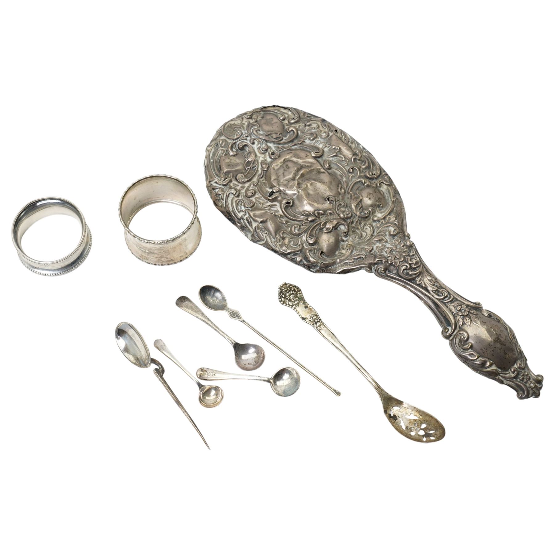 Two silver napkin rings, silver mirror frame and various silver spoons