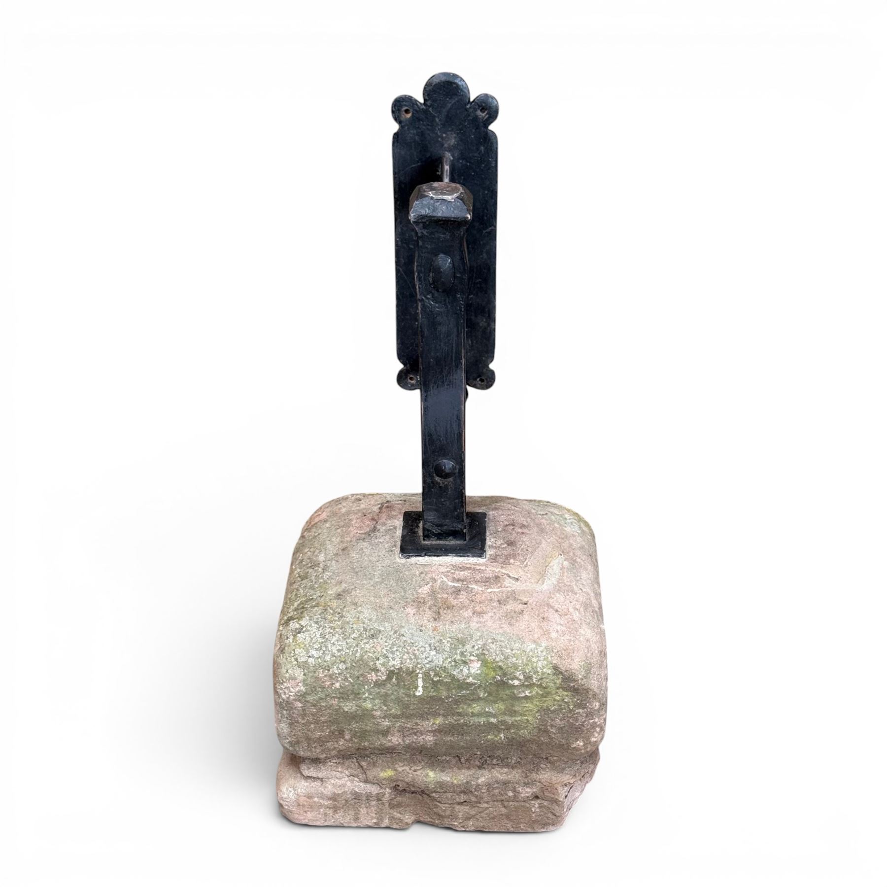 Large wrought metal boot scraper in black painted finish, set in formed stone plinth