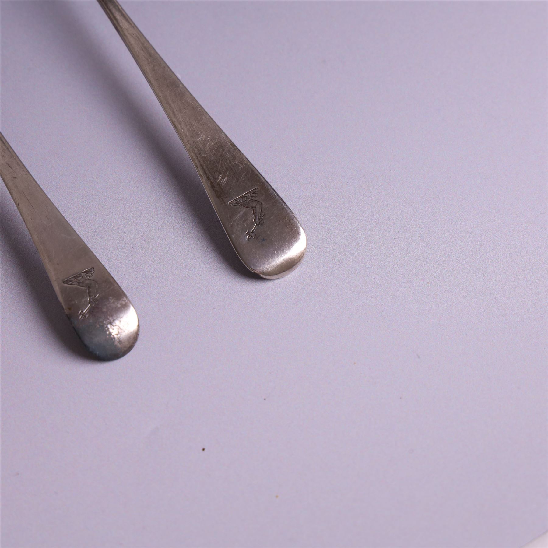 Two George III Old English pattern silver spoons, each engraved with arm and hammer crest to terminal, both hallmarked