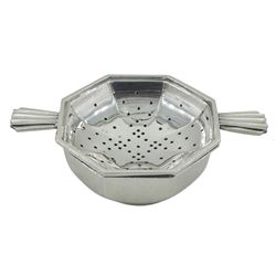 Mid 20th century silver tea strainer and bowl, each of octagonal form, the strainer with twin fan handles, hallmarked William Suckling Ltd, Birmingham 1946, including handles L11cm, approximate weight 2.99 ozt (93 grams)