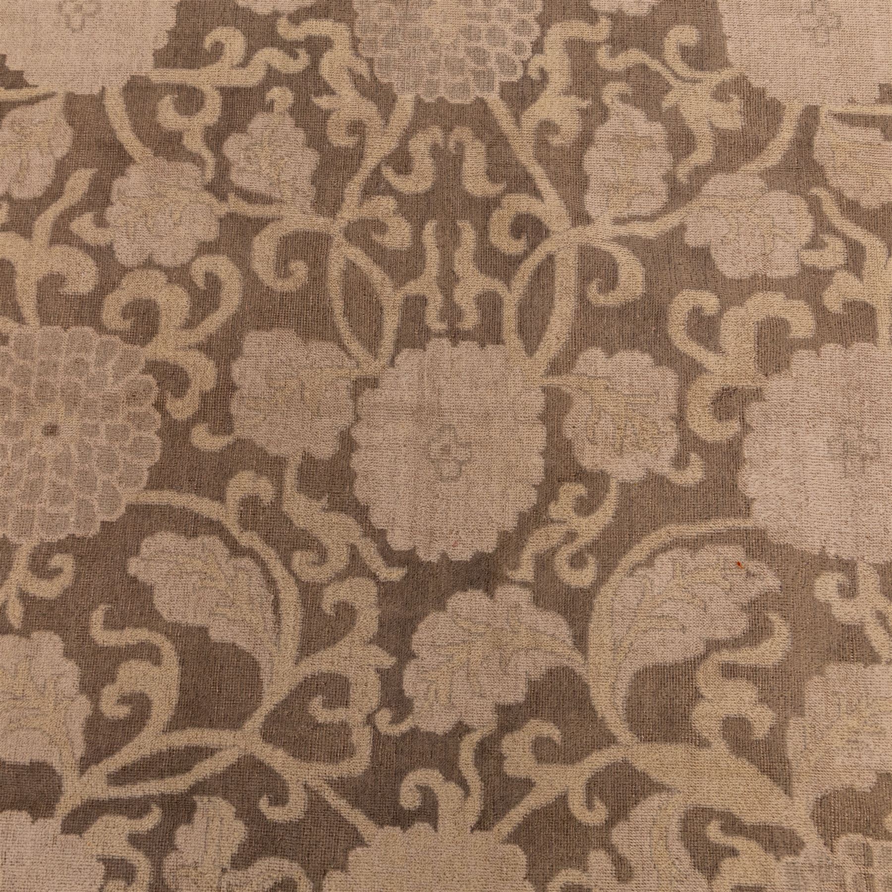 Indian Khetar hand knotted carpet, the brown ground decorated with an all over scrolling foliate and palmette design, enclosed within a conforming floral border with guard stripes