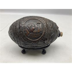 19th century bug bear flask carved with Balkan figures, a wolf and leafage with glass eyes, L14cm on stand 