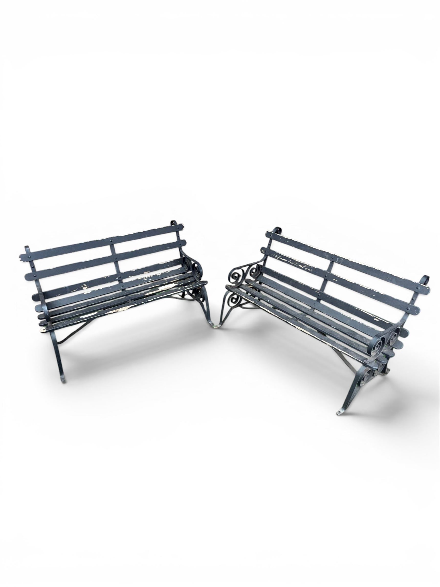 Coalbrookdale - rare pair of wrought iron and slatted wood garden benches, the twin wrought iron strapwork bench-ends formed of four scrolls over splayed feet, number 77 in the Coalbrookdale Castings Catalogue (see illustration)