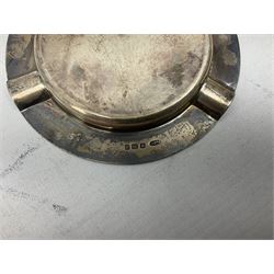 Two early 20th century silver trumpet vases to include a Martin Hall & Co Ltd example, silver circular box raised on three feet stamped Birmingham 1912, ashtray hallmarked London 1945, silver backed hair brush with engine turned decoration etc, tallest H19.5cm