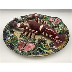 Two 20th Century Portuguese Palissy style Majolica wall plates, one depicting a crab, the other a lobster each to the centre modelled in relief surrounded by encrustations and shells, both with impress marks beneath, D34cm
