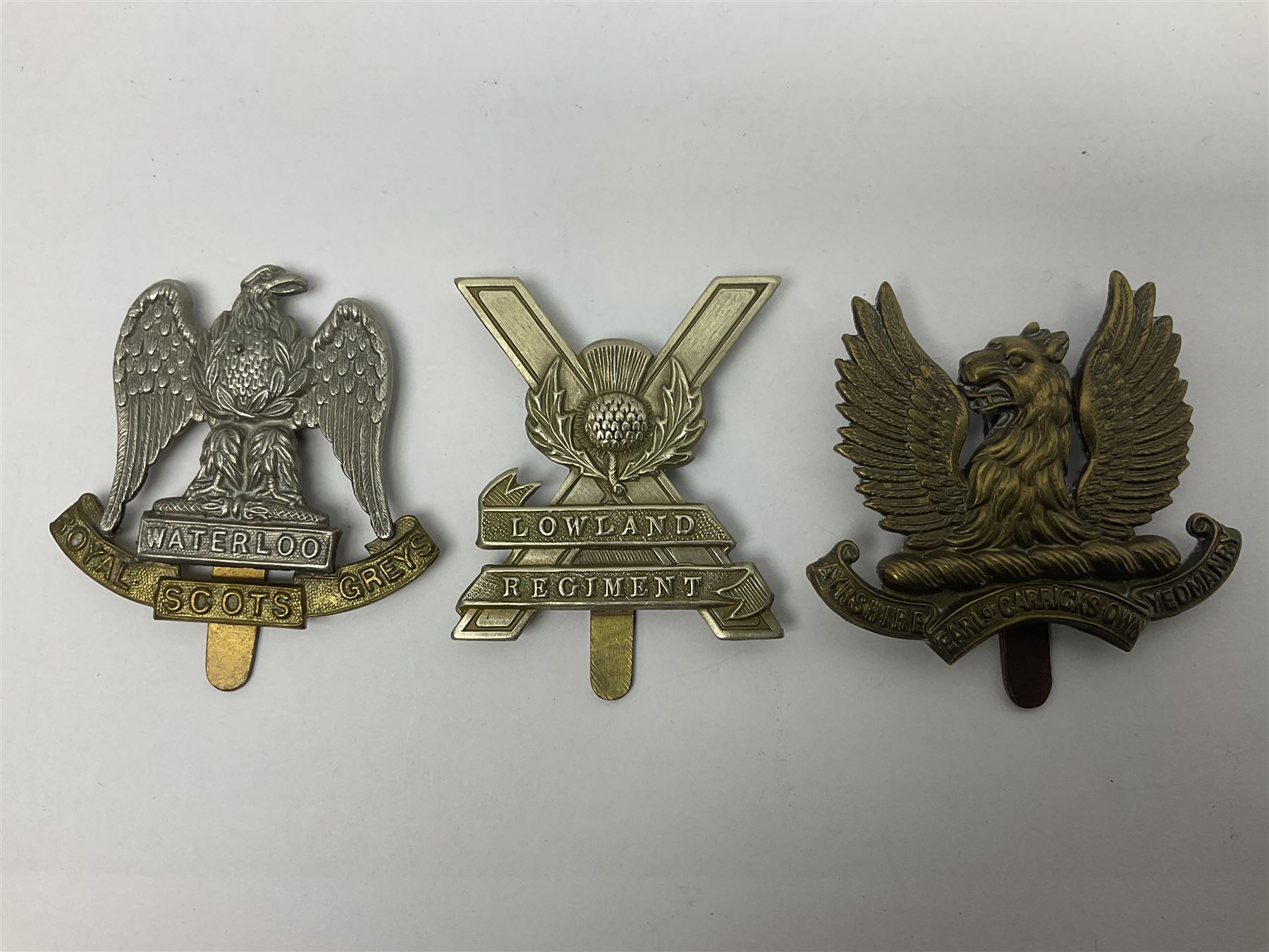 Fifteen Scottish Glengarry and other metal military badges including Argyll & Sutherland, Royal Glasgow Yeomanry, Cameronians, Lanarkshire Yeomanry, Kings Scottish Own Borderers, Highland Light Infantry, Border Regiment, Lowland Regiment, Lothians & Border Horse Yeomanry, Ayrshire Earl of Carricks Own Yeomanry etc