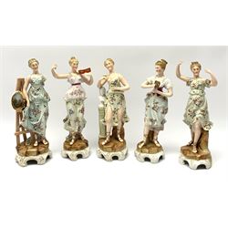 A group of five Continental figurines modelled as the arts, emblematic of music, painting, sculpture, literature, and theatre, each with spurious blue cross mark beneath, H22.5cm. (5). 