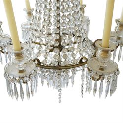 Regency Country House cut-glass and ormolu six light chandelier, the outer shaft with ormolu foliate moulding hung with octagonal and drop pendants, the impressive central shaft with cascading drops of cut-glass, the scroll branches with hob-nail cut candle holders and wax pans, with central similarly cut terminal
Provenance: property of a nobleman
