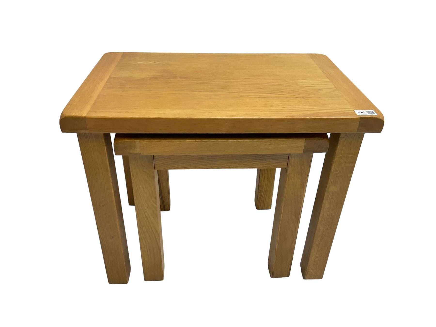 Light oak nest of two tables, rectangular top raised on square supports