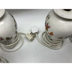 Two Portmeirion Botanic Garden table lamps, together with two Portmeirion Botanic Garden planters
