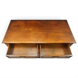 18th century style oak dresser base, rectangular moulded top over two frieze drawers with brass handles, twin panelled cupboard doors below with pierced brass escutcheons, on stile feet
